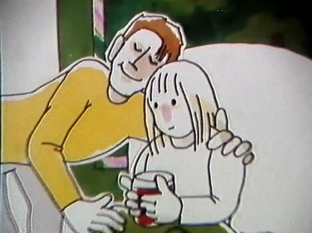 He sits on the bed with an arm round her as she drinks from a mug.