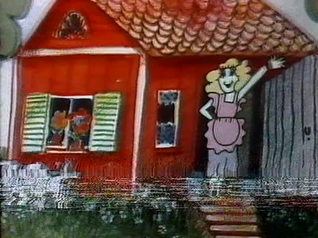 A woman, a child on a tricycle and a dog on the grass beside the red house.
